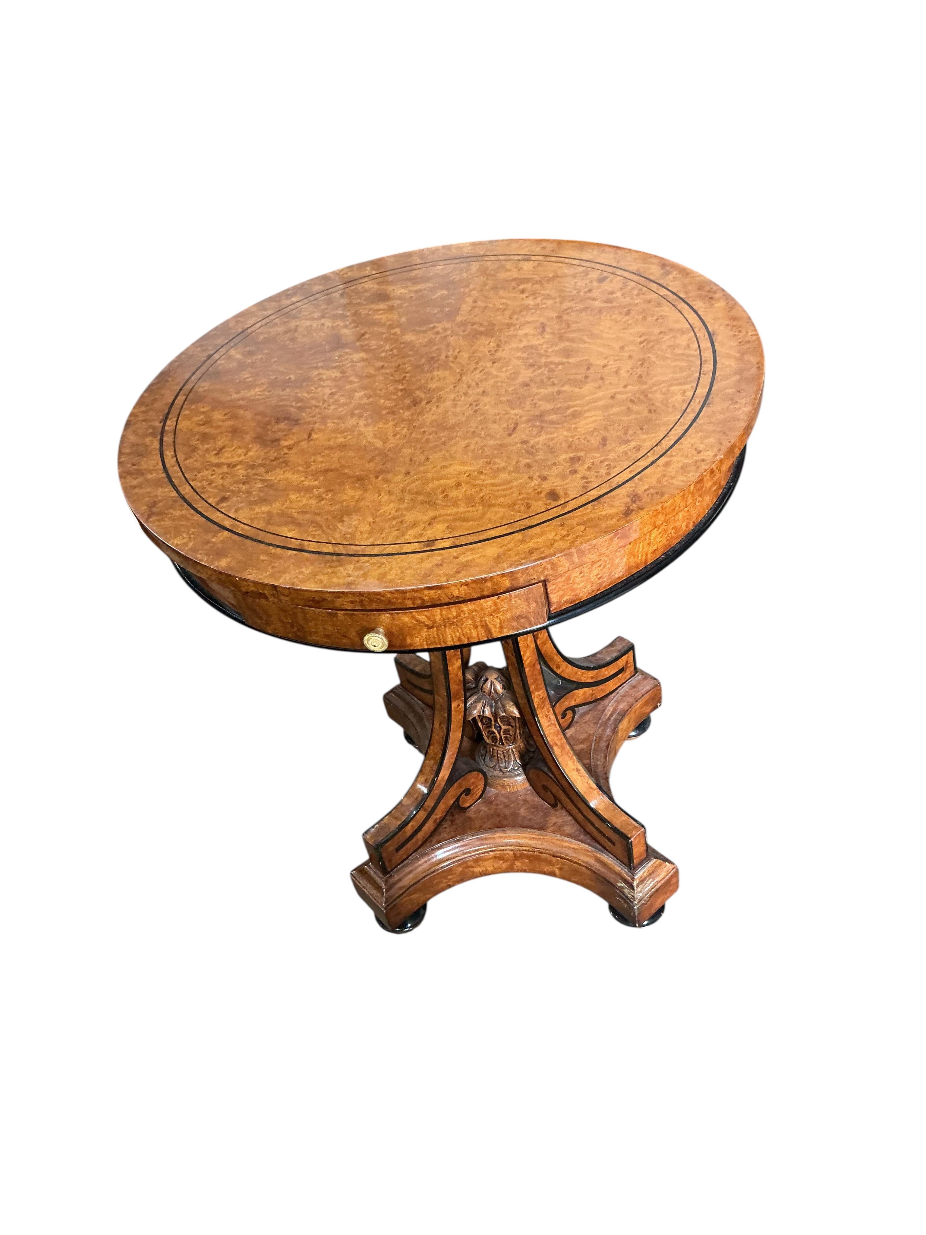 A Regency style part ebonised bird's eye maple circular centre table, diameter 64cm, height 74cm
